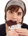 Stressed girl eating chocolate bar